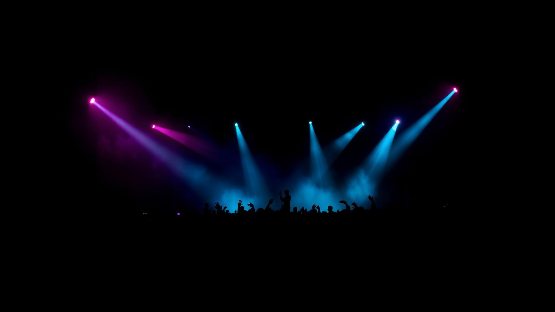 Crowd lit by pink and blue stage lights